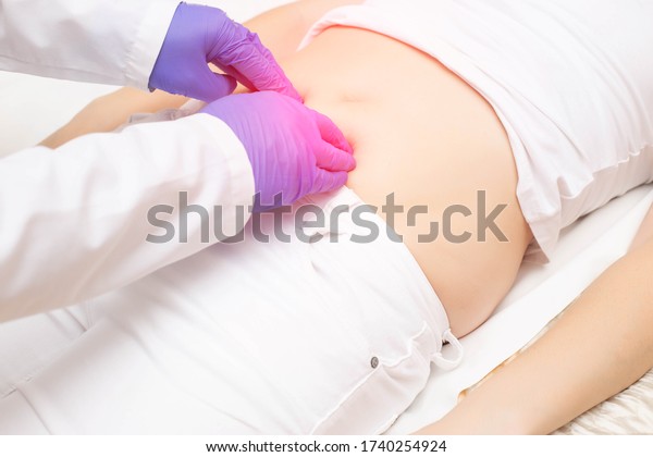 The doctor probes\
the lower abdomen in a girl who has pain and inflammation of the\
bladder. The concept of diseases in girls cystitis, kidney stones,\
dysmenorrhea