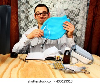 Doctor Proctologist  Holding An Enema Bag