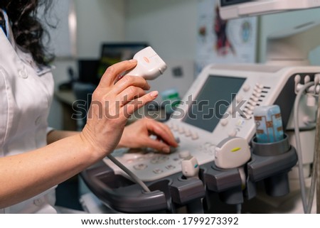 Doctor with professional equipment. Ultrasound scanner in doctor`s hands. Diagnostics. Sonography