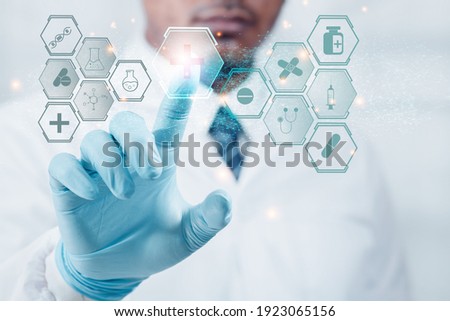 Doctor or a professional scientist Hand with anti-virus gloves points to the graphic, technology, mark, medical protection. The concept of antivirus protection with technology