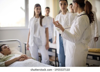 Doctor professor talking with students.  Group of people in patient room.  - Shutterstock ID 1955537110