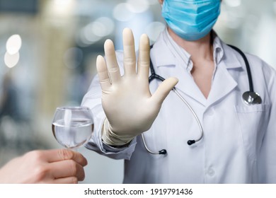 Doctor Prohibits Drinking Alcohol With Hand Gesture On Blurred Background.