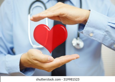 doctor is protecting heart  with hands. Health care and  Cardiovascular diseases  concept
