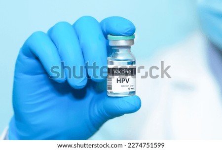 Doctor in protective gloves holding a HPV (human papillomavirus) vaccine .The concept of medicine, healthcare and science