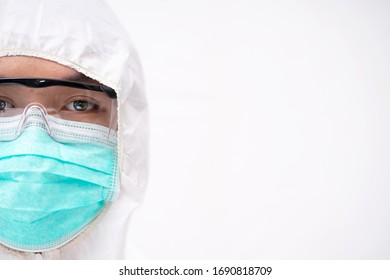 Doctor In Protective PPE Suit Wearing Face Mask And Eyeglasses