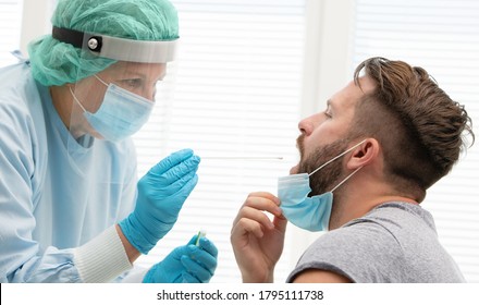 Doctor in a protective suit taking a throat and nasal swab from a patient to test for possible coronavirus infection - Shutterstock ID 1795111738