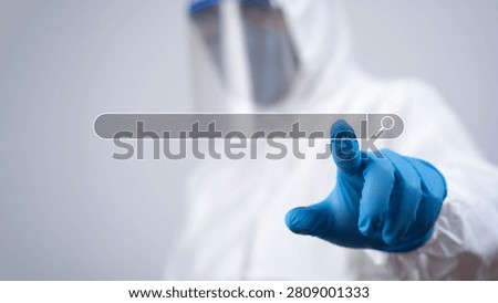 Doctor in protective suit using virtual search interface for digital healthcare data, representing telemedicine, online medical services, healthcare technology and smart diagnostics.