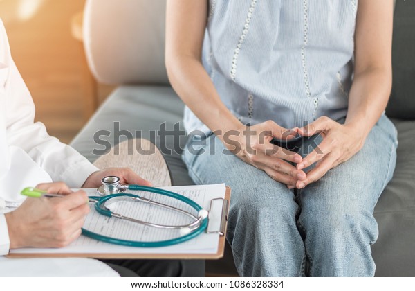 Doctor or psychiatrist consulting and diagnostic\
examining stressful woman patient on obstetric - gynecological\
female illness, or mental health in medical clinic or hospital\
healthcare service\
center