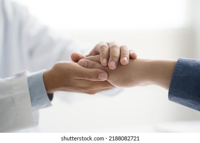 Doctor or psychiatrist shakes hands encouragement the patient and care having a consultation on diagnostic examination on male disease or mental illness in a clinic or hospital mental health service  - Shutterstock ID 2188082721