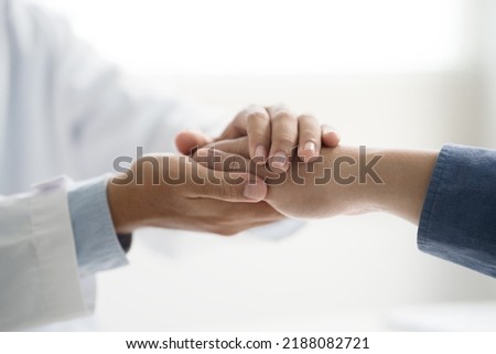 Doctor or psychiatrist shakes hands encouragement the patient and care having a consultation on diagnostic examination on male disease or mental illness in a clinic or hospital mental health service 