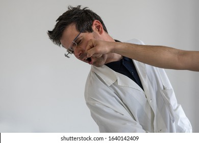 Doctor Punched In The Face. Concept Of Violence And Aggression On Doctors And Healthcare Professionals