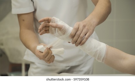 Doctor Puts Gypsum Pad On Patient's Hand