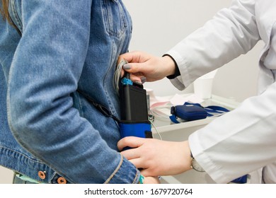 The Doctor Puts On A Girl A Black Halter To Monitor The ECG Of The Heart In The Cardiology Clinic