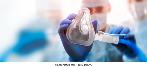 Doctor puts on oxygen mask. Emeregency and first aid concept. - Shutterstock ID 1692460999