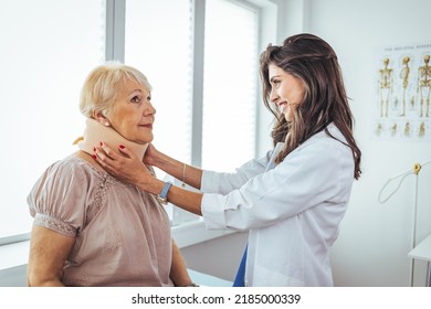 Doctor putting neck orthopaedic collar on adult injured woman. Doctor talking to a senior patient with cervical collar at the hospital. Doctor applying cervical collar on neck of woman in clinic