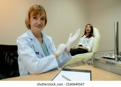 Doctor Putting On Gloves For Protect Disease.confident Physician In Lab Coat .