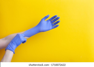 Doctor Putting On Hand Nitrile Professional Medical Purple Gloves