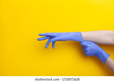 Doctor Putting On Hand Nitrile Professional Medical Purple Gloves