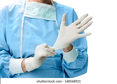 Doctor putting on white sterilized surgical gloves