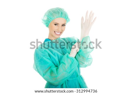 Doctor putting sterilized medical glove for operation.