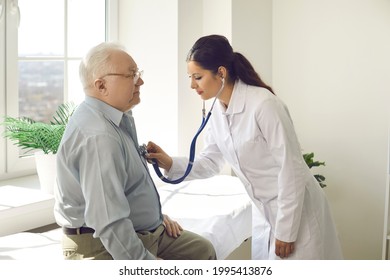 Doctor Putting Stethoscope On Patient Chest Listen Heartbeat And Lungs Breath. Elderly Male Person Exam At Hospital Ward. Cardiologist Physician Appointment. Nursing Home Clinic Service For Pensioner