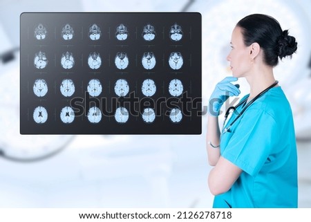 Doctor radiologist looks at the MRI, ultrasound, the child's brain in the CT scan room. Soft blurred background. Medical poster. kids vaccine