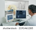 Doctor radiologist running CT scan for patient