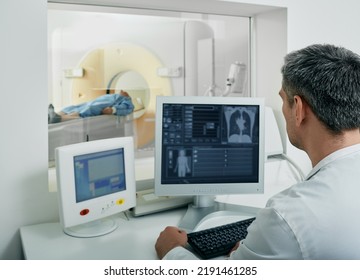 Doctor radiologist running CT scan for patient's body lungs from control room. Computed Tomography - Shutterstock ID 2191461285