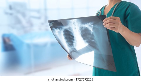 Doctor Radiology Looking Chest X-ray Film Of Patient At Hospital.