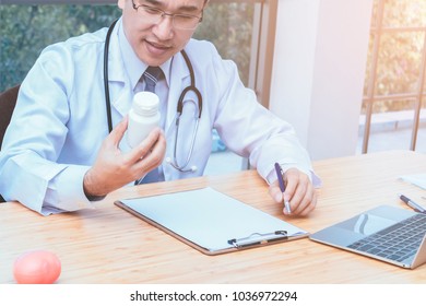 Doctor Reading Drug Label Of Bottle Medicine For Give Medicine To Patients. Medical And Health Care Concept.