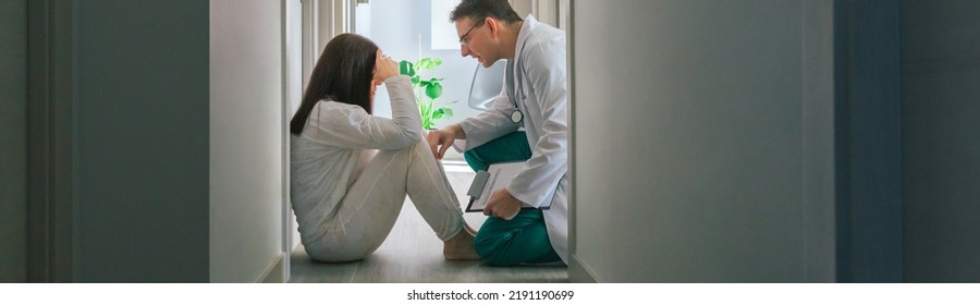 Doctor Reassuring With Empathy A Female Patient Sitting On The Floor Of A Mental Health Center