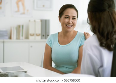 Doctor reassuring Vietnamese woman