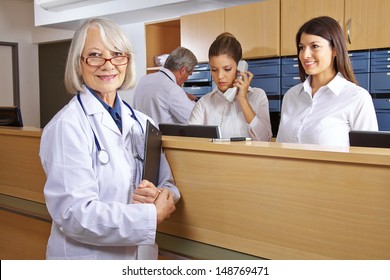 Doctor And Receptionist At Reception In A Hospital