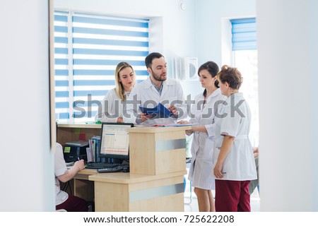 Doctor and receptionist at reception in a hospital