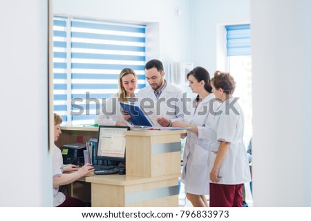 Doctor and receptionist at reception in a hospital