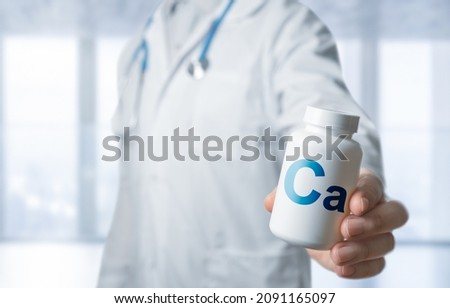 Doctor recommends taking Ca, calcium supplement, vitamins, food supplement. doctor giving pill jar to patient. Practitioner with bottle of pills. hand hold white plastic pill bottle