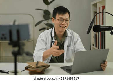 Doctor recording making medication advise via online podcast, online medical blog from home - Shutterstock ID 2291499317