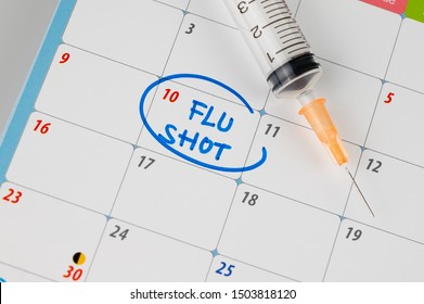 Doctor reminder flu shot in calendar with syringe, medicine and vaccine concept