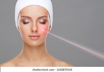 Doctor Removing Moles Using Laser Ray. Beauty Portrait Of A Young Woman. Birthmark Removal, Plastic Surgery, Skin Lifting And Aesthetic Medicine.