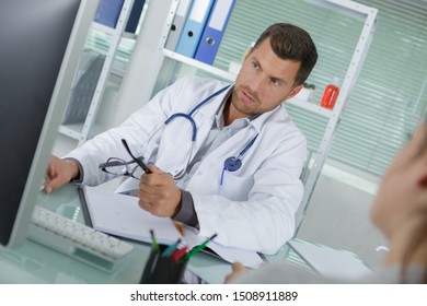 Doctor Reviewing The Condition File