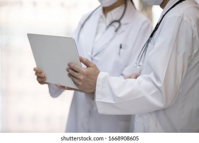 Doctor Reviewing Medical Data With Laptop