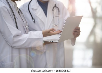 Doctor Reviewing Medical Data With Laptop