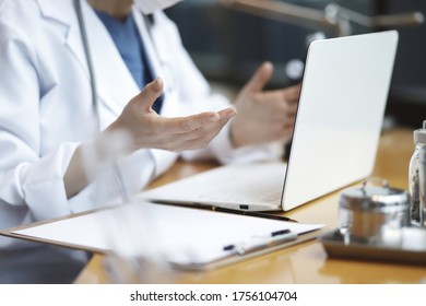 Doctor Reviewing Medical Data With Laptop