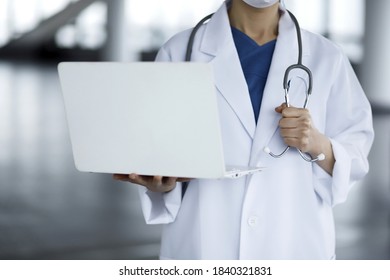 Doctor Reviewing Medical Data With Laptop