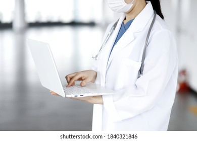 Doctor Reviewing Medical Data With Laptop