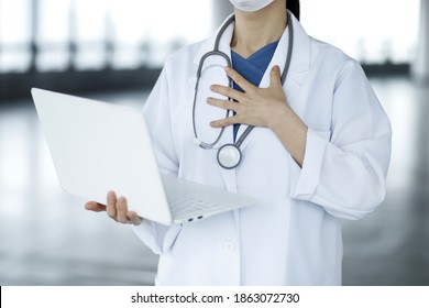 Doctor Reviewing Medical Data With Laptop