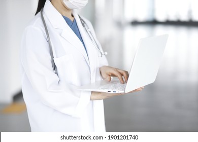 Doctor Reviewing Medical Data With Laptop
