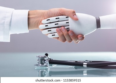 Doctor And Robot Shaking Hands Over Stethoscope