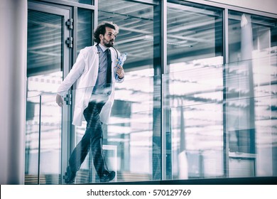 Doctor Rushing In Hospital Corridor