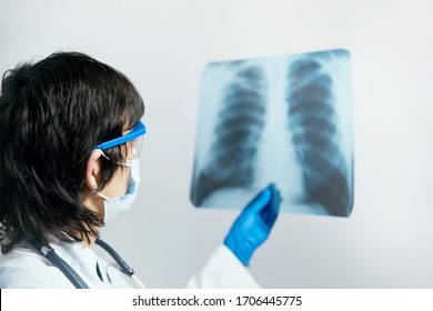 Doctor Scientist Checking Examining Viral Infection Or Pneumonia Lesion On Chest X-ray Film. Coronavirus 2019,COVID-19